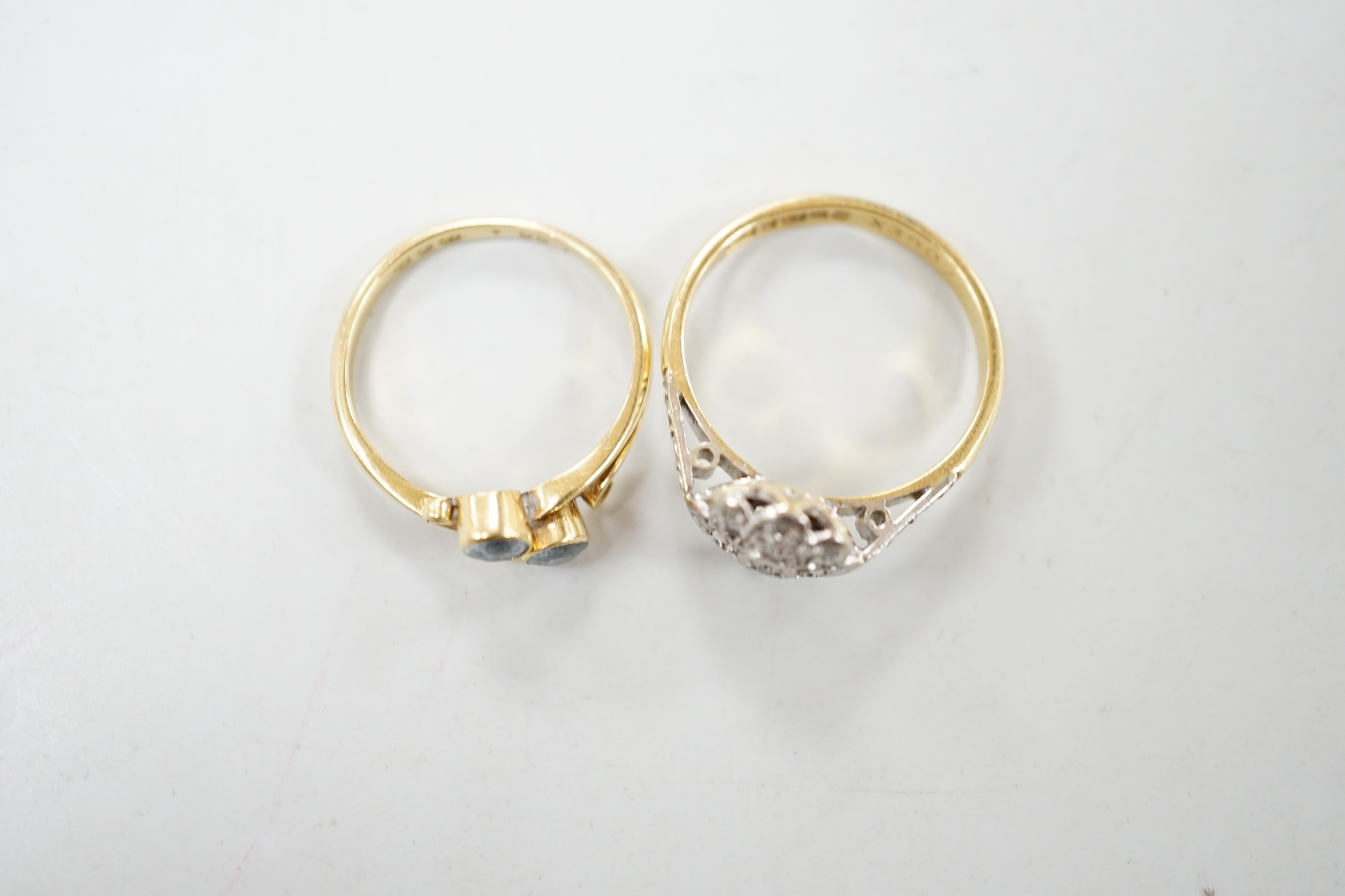 Two 18ct gold and gem set rings including illusion set diamond and blue stone crossover, gross weight 5.3 grams.